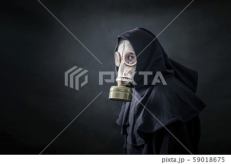 Man in a gas mask and hooded cloak. Environment pollution. Man in a gas mask and hooded cloak. Environment pollution. 59018675