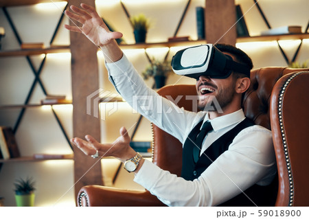 Man wearing virtual reality goggles Man wearing virtual reality goggles 59018900