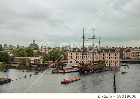 National Maritime Museum with sailboat docked in Amsterdam 59019000