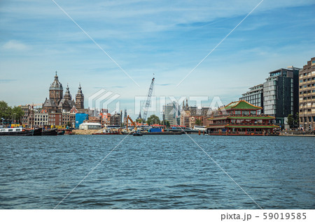 Port with ships, church towers and pagoda building in Amsterdam 59019585