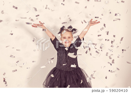 Party, holidays, new year and celebration concept - Female child throwing confetti. 59020410