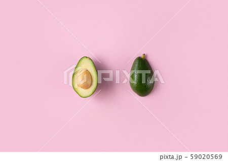 Avocado halves isolated on pink top view 59020569