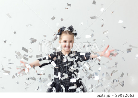 Party, holidays, new year and celebration concept - Female child throwing confetti. Party, holidays, new year and celebration concept - Female child throwing confetti. 59022062