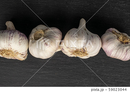 White aromatic garlic on grey stone White aromatic garlic on grey stone 59023044