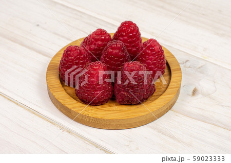 Fresh red raspberry on grey wood Fresh red raspberry on grey wood 59023333