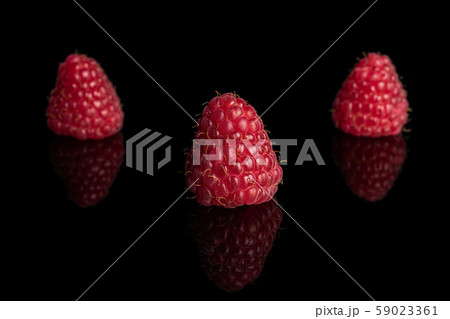 Fresh red raspberry isolated on black glass Fresh red raspberry isolated on black glass 59023361