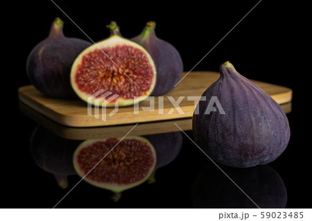 Fresh purple fig isolated on black glass Fresh purple fig isolated on black glass 59023485