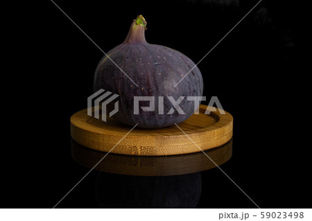 Fresh purple fig isolated on black glass Fresh purple fig isolated on black glass 59023498