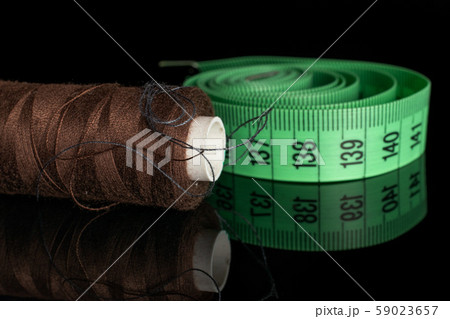 Haberdashery item isolated on black glass Haberdashery item isolated on black glass 59023657