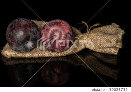 Fresh red plum isolated on black glass 59023755