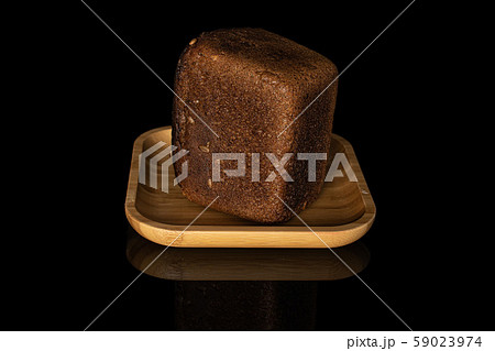 Fresh baked dark bread isolated on black glass Fresh baked dark bread isolated on black glass 59023974
