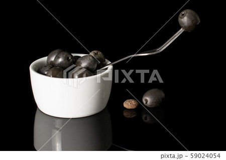 Black canned olive isolated on black glass 59024054