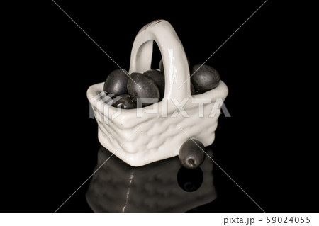 Black canned olive isolated on black glass 59024055