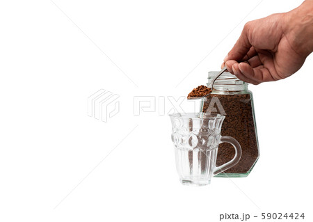Hand man holding powder instant coffee from a spoon put in a coffee cup on white background Hand man holding powder instant coffee from a spoon put in a coffee cup on white background 59024424