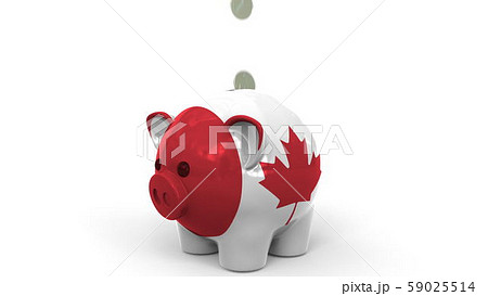 Coins fall into piggy bank painted with flag of Canada. National banking system or savings related Coins fall into piggy bank painted with flag of Canada. National banking system or savings related 59025514