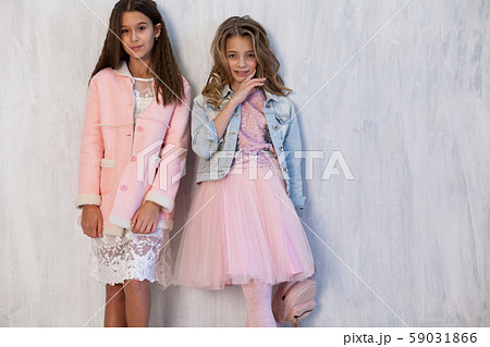 Portrait of two fashionable schoolgirl girls girlfriend in pink clothes 59031866