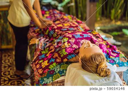 Young beautiful relaxing woman getting spa massage of shoulder in beauty salon Young beautiful relaxing woman getting spa massage of shoulder in beauty salon 59034146