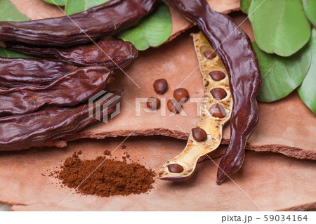 Carob. Organic carob pods with seeds and leaves Carob. Organic carob pods with seeds and leaves 59034164