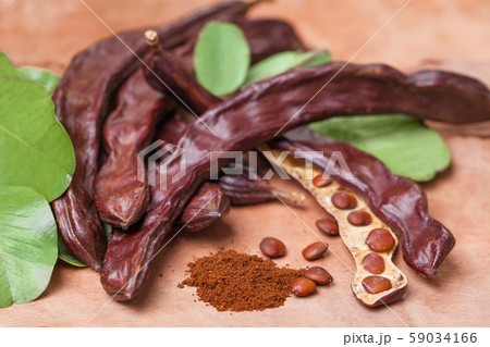 Carob. Organic carob pods with seeds and leaves Carob. Organic carob pods with seeds and leaves 59034166