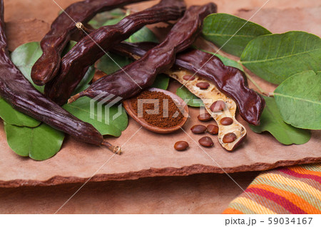 Carob. Organic carob pods with seeds and leaves Carob. Organic carob pods with seeds and leaves 59034167