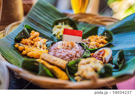 Nasi lemak, Nasi campur, Indonesian Balinese rice with potato fritter, sate lilit, fried tofu, spicy 59034237