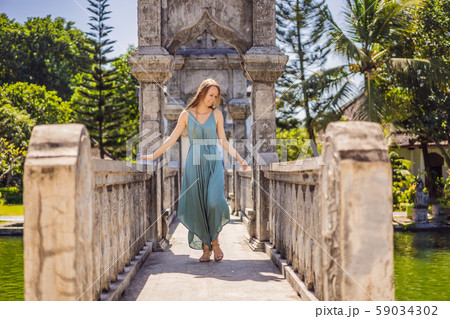 Young woman in dress in Water Palace Soekasada Taman Ujung Ruins on Bali Island in Indonesia 59034302