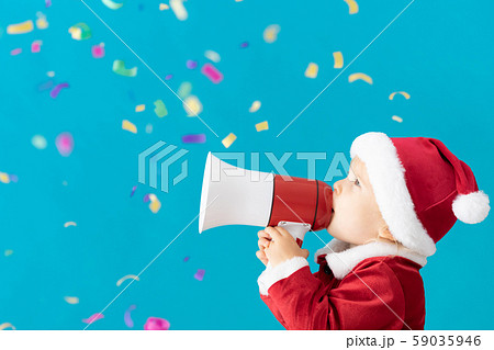 Happy child wearing Santa Claus costume speaking Happy child wearing Santa Claus costume speaking 59035946