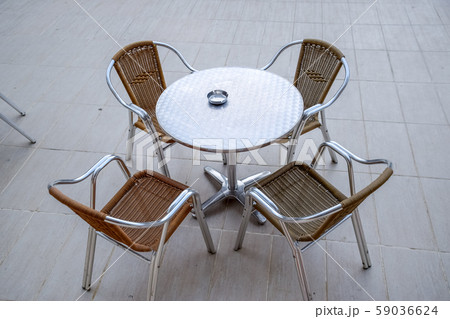 Metal tables and chairs with wicker seats in 59036624