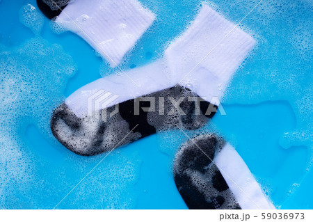 Dirty socks soaking in powder detergent water Dirty socks soaking in powder detergent water 59036973