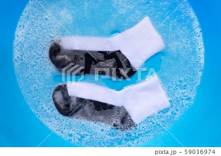 Dirty socks soaking in powder detergent water Dirty socks soaking in powder detergent water 59036974