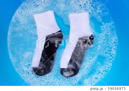 Dirty socks soaking in powder detergent water Dirty socks soaking in powder detergent water 59036975