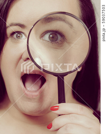 Adult woman with magnifying glss 59037503