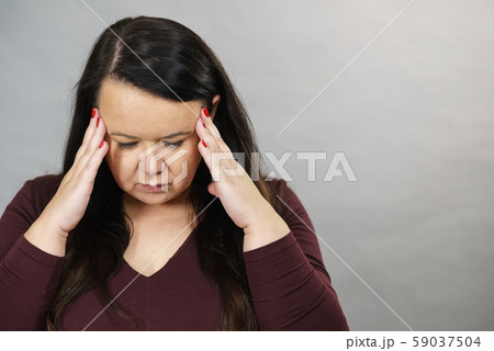 Worried woman having painfull headache 59037504
