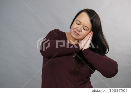 Woman being sleepy gesturing 59037505