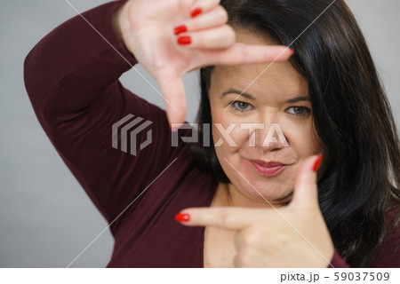 Big woman making frame with hands 59037509