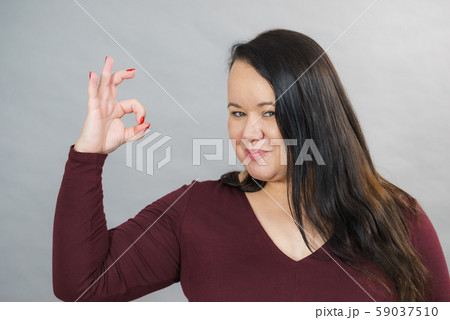 Woman making thumb up gesture 59037510
