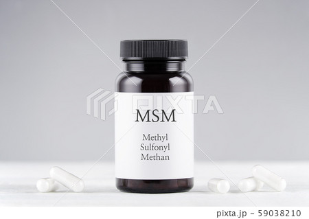 nutritional supplement msm, sulfur, methylsulfonylmethan bottle and capsules on gray 59038210