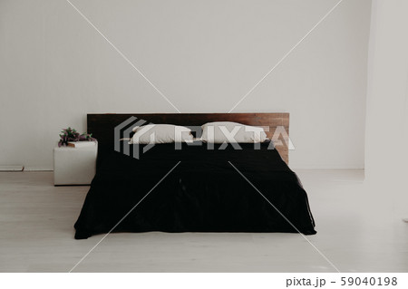 Interior white bedroom and bed with black sheets 59040198