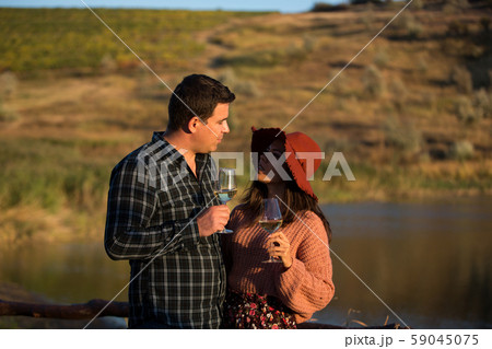 Wine grower family in a vineyard enjoying a glass of wine 59045075