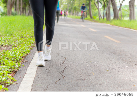 Fitness woman legs exercise walking on park trail in the morning. Fitness woman legs exercise walking on park trail in the morning. 59046069