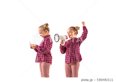 Young handsome girl arguing with herself on white studio background. Young handsome girl arguing with herself on white studio background. 59046311