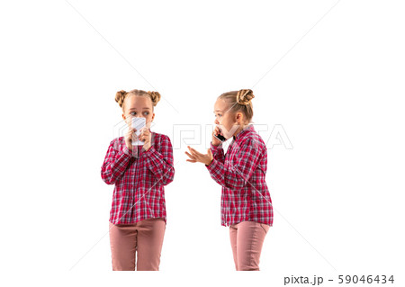 Young handsome girl arguing with herself on white studio background. 59046434
