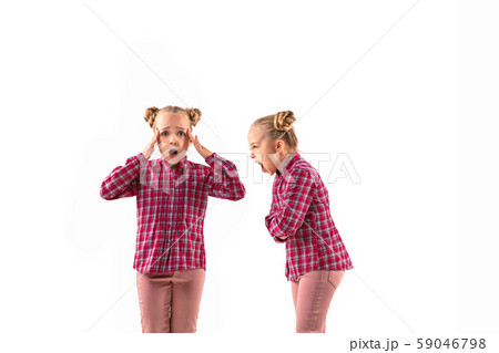 Young handsome girl arguing with herself on white studio background. 59046798