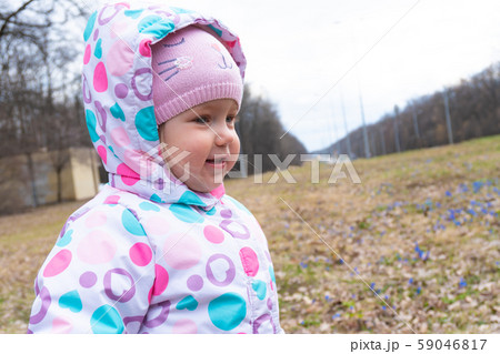 Girl and some first blue snowdrop flowers behind Girl and some first blue snowdrop flowers behind 59046817