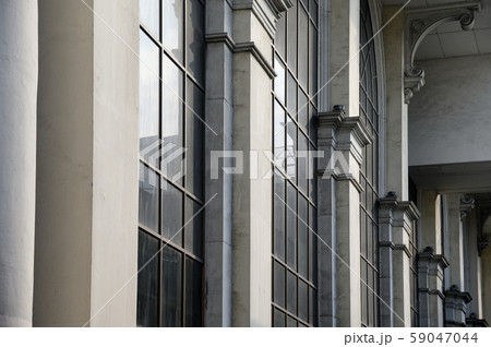 Cement pillar of roman style with black windows 59047044