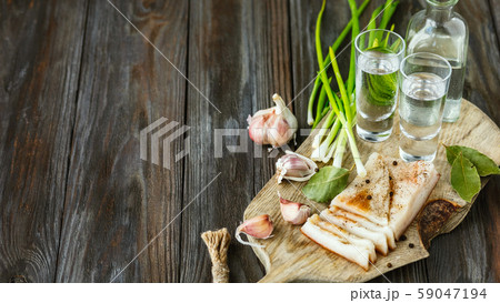 Vodka and traditional snack on wooden background 59047194