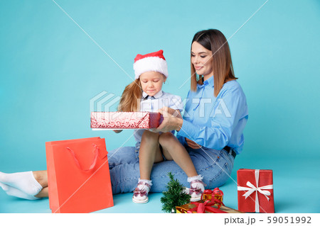 New Year time concept. Mom and kid together sitting with gifts. 59051992