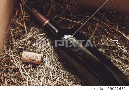 Sommelier Concept. Wine bottle on hay close-up Sommelier Concept. Wine bottle on hay close-up 59052685