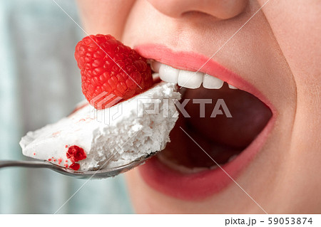 Break the Diet. Chubby girl sitting at kitchen table eating cake mouth close-up 59053874