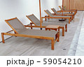 Chair loungers by the pool 59054210